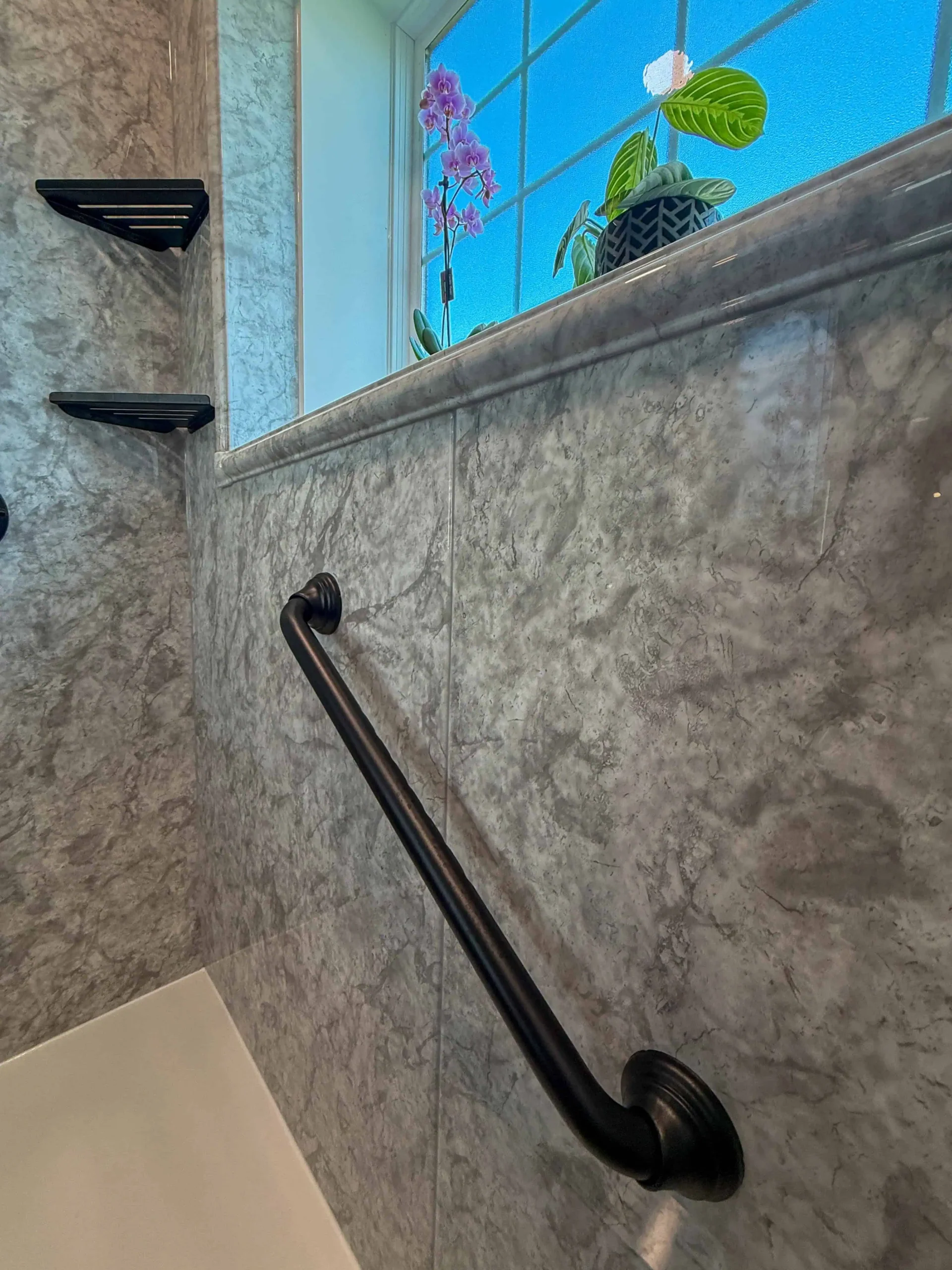 Updated bathroom with improved storage and a relaxing freestanding tub for comfort.