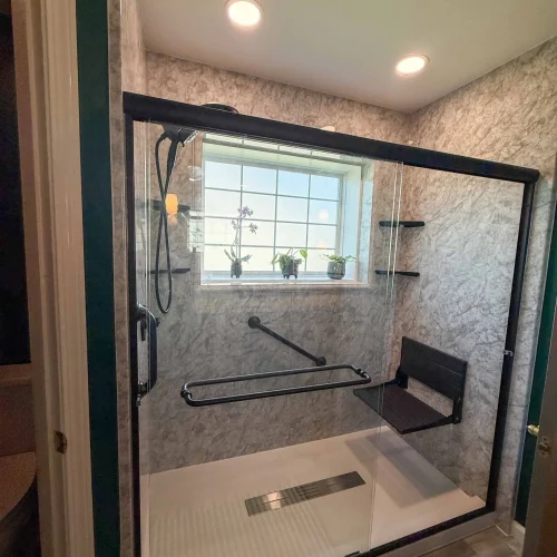 Stylish bathroom renovation showcasing a sleek shower and ample storage solutions.