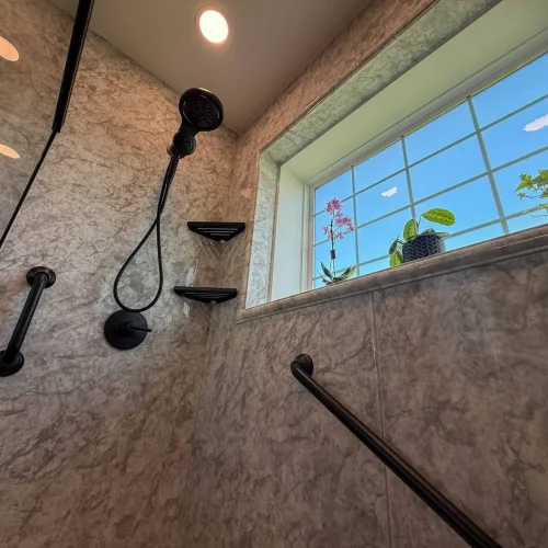 Modern bathroom remodel featuring a freestanding tub and spacious shower area.