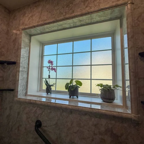 Stylish bathroom remodel showcasing a modern shower and ample storage space.