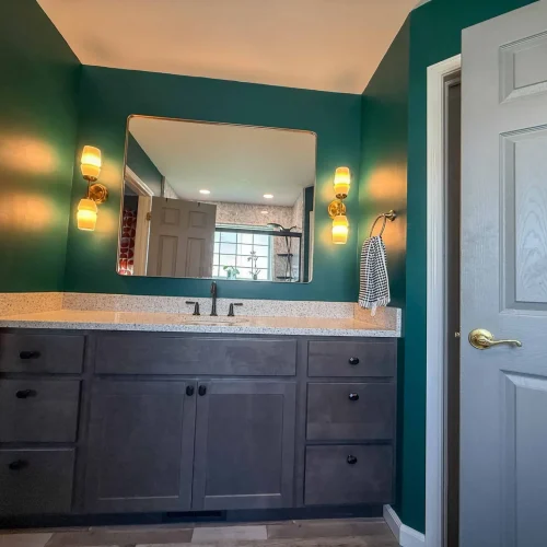 Stylish bathroom renovation showcasing a sleek freestanding tub and ample storage solutions.