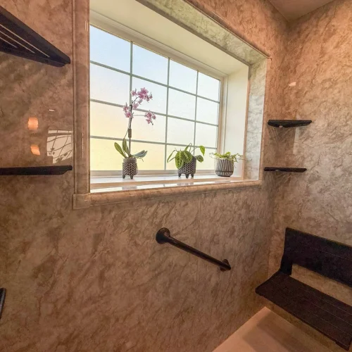 Bright and functional bathroom renovation with a modern shower and ample storage.