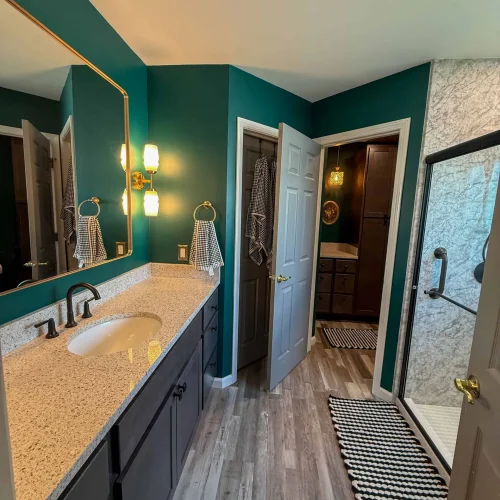 Brightly lit bathroom remodel with modern fixtures and ample storage for a functional space.