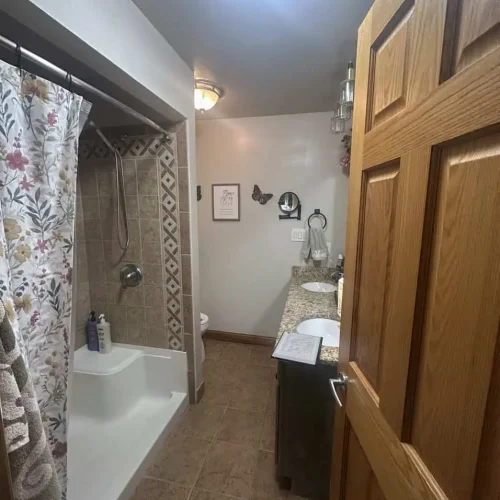 Outdated tiled upstairs shower before bathroom remodeling in Lakes of the Four Seasons.